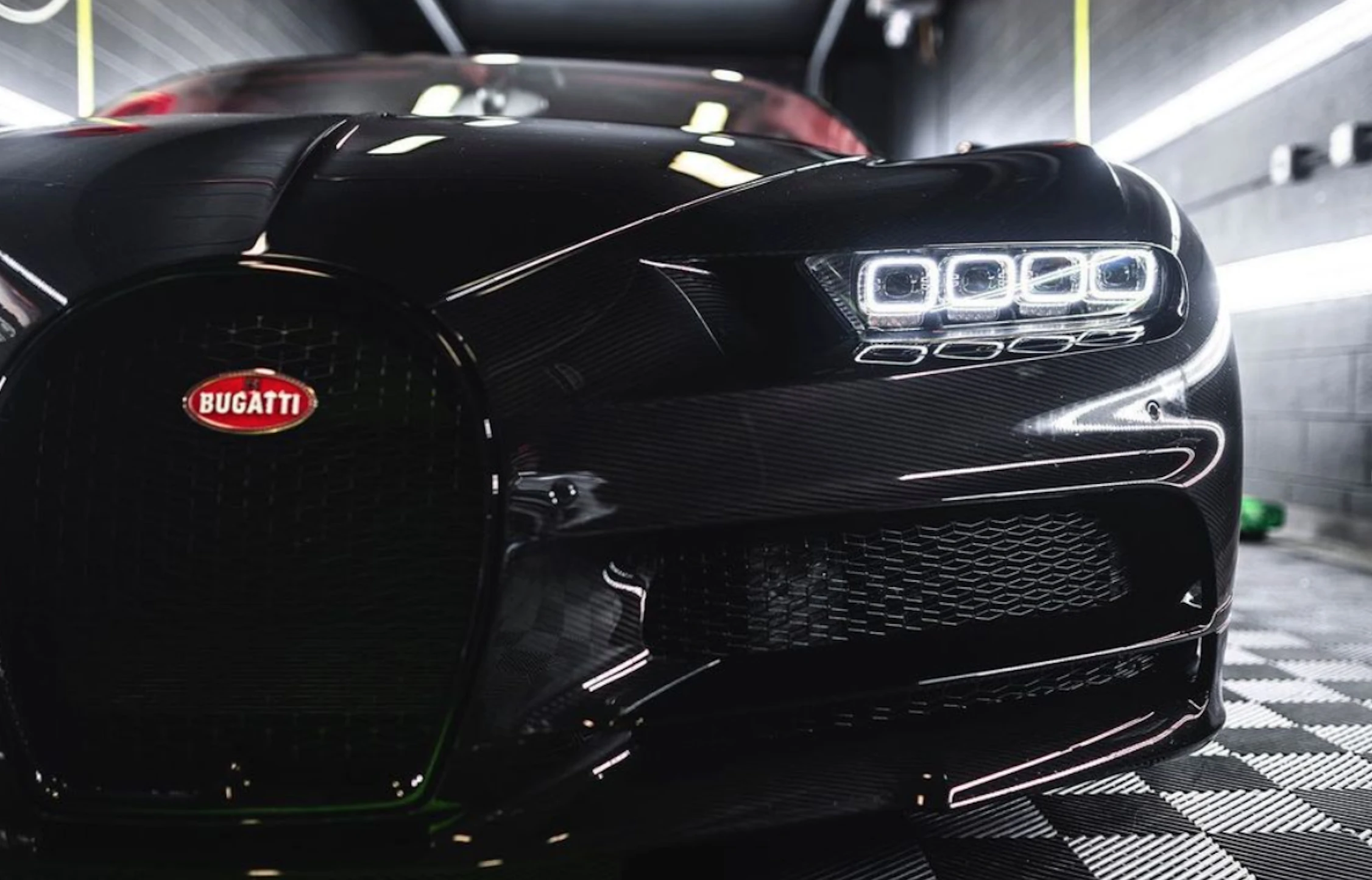 frontal view of a shiny black bugatti
