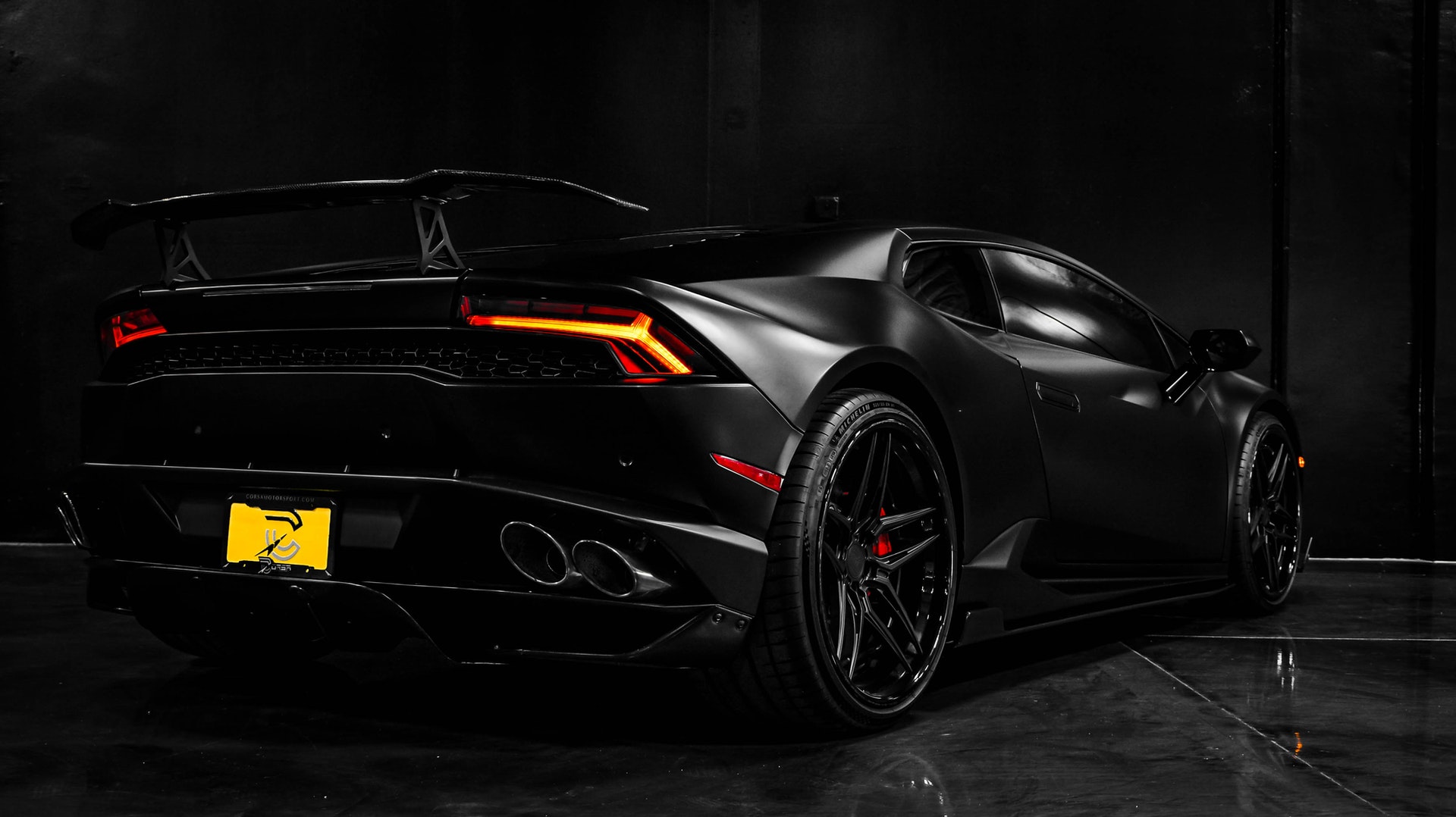 full view of a stylish black sportscar from the back