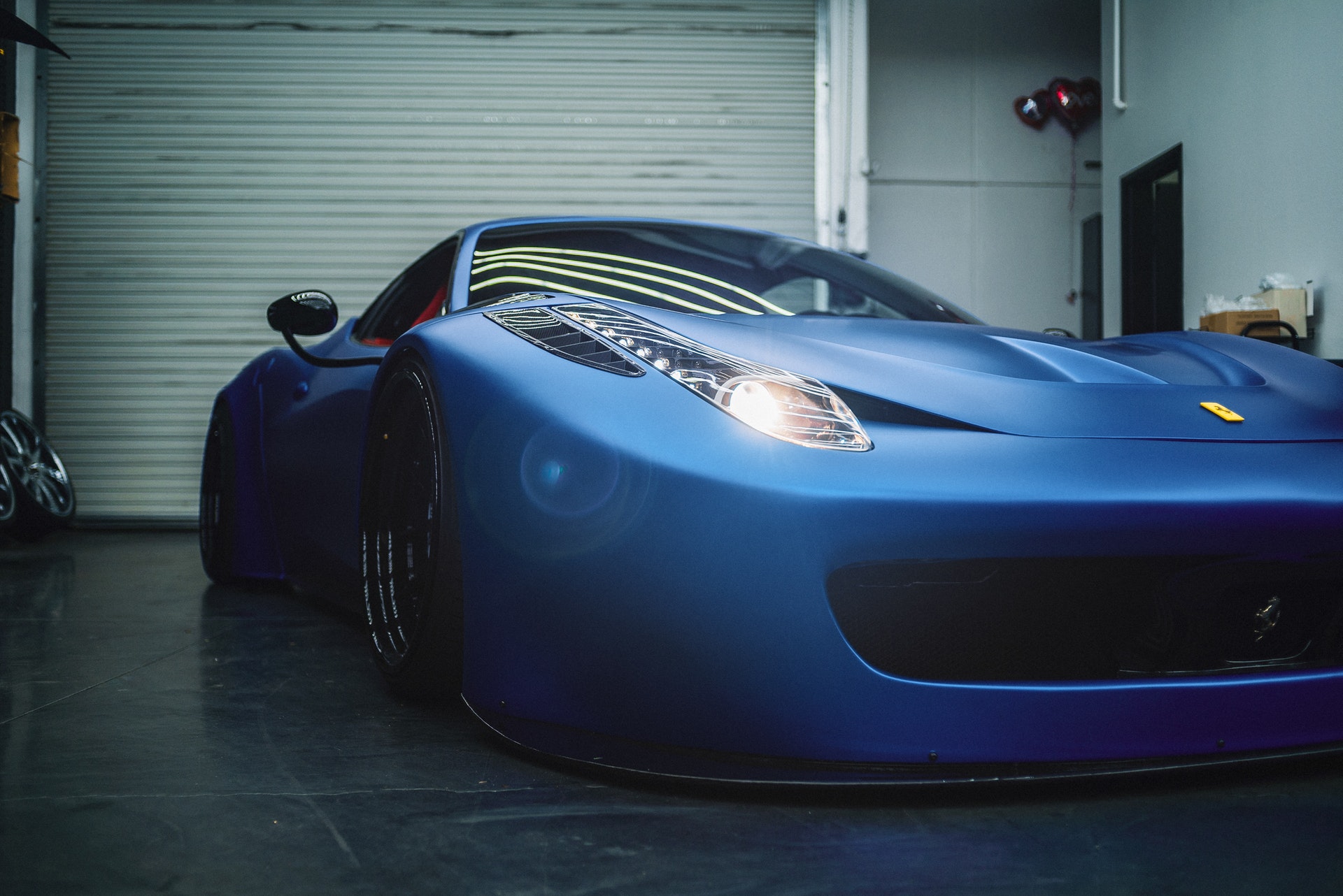 blue sports car in a garage